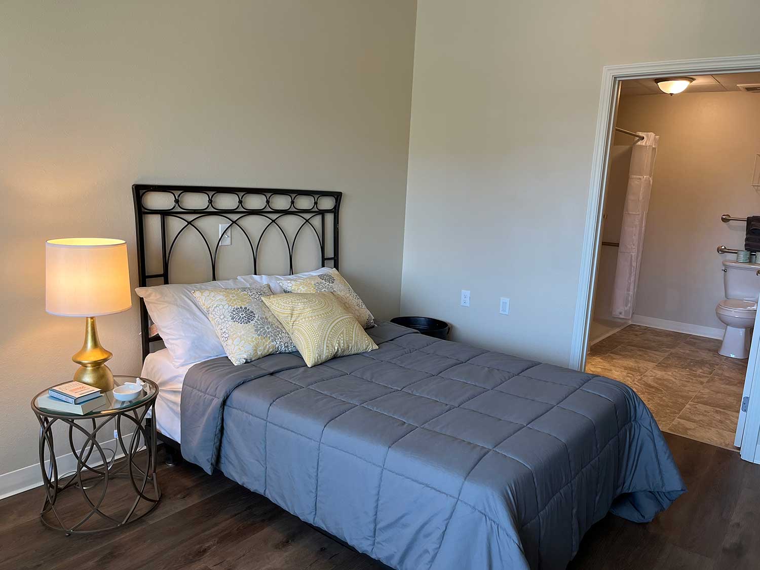 The Rosemount, Understanding Care Suites, featured image, bed and side table, bath, comforting colors and arrangement